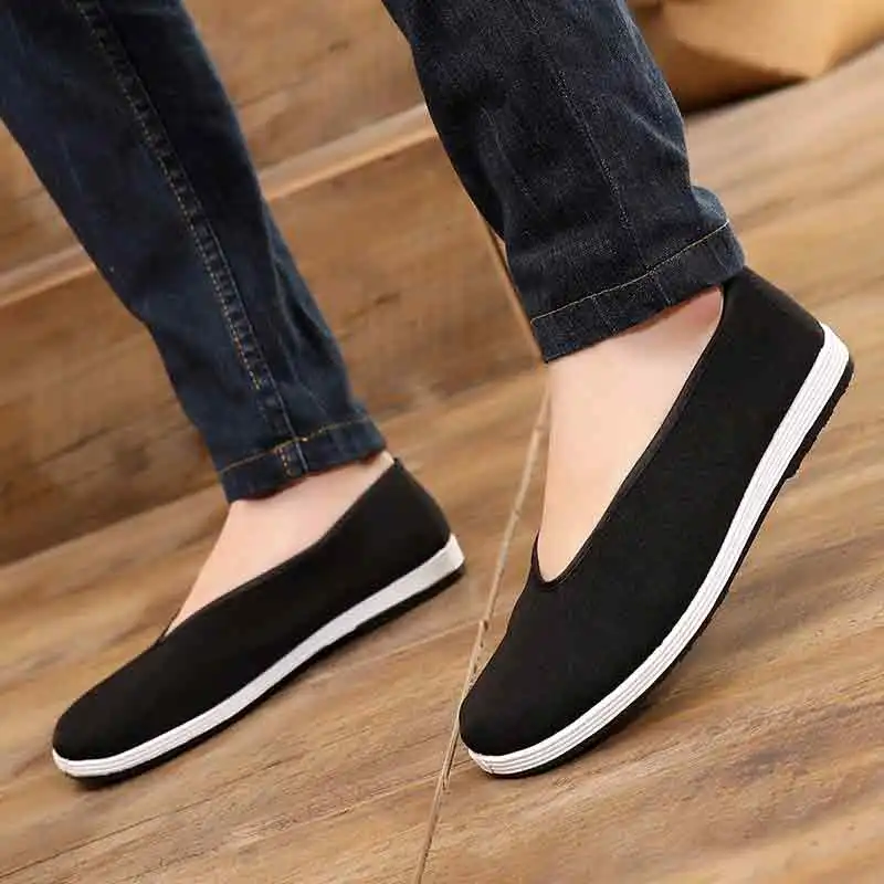 Close-up detail of cotton cloth construction and round toe design on Wing Chun martial arts shoes.