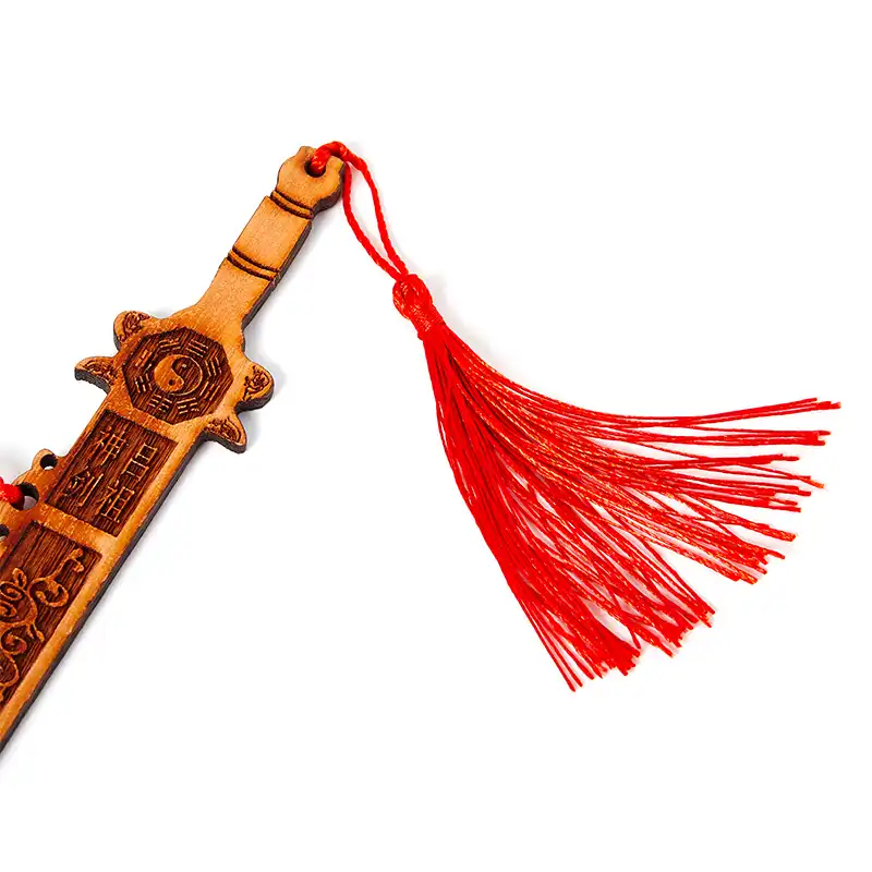 Close-up detail of Eight Diagrams bagua carving on authentic peach wood sword surface showing craftsmanship.