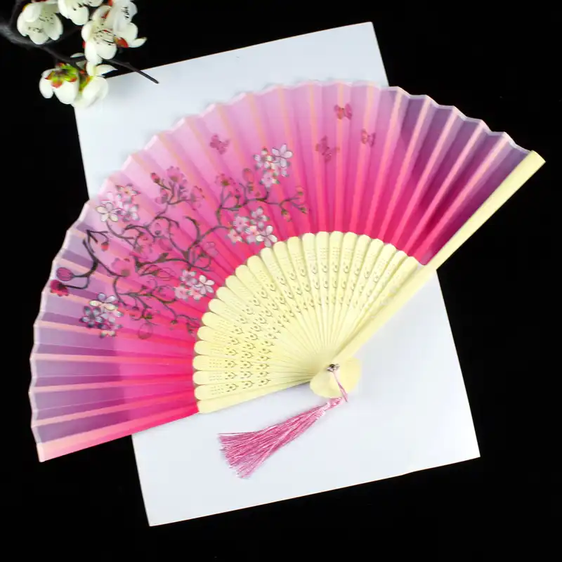 Traditional Chinese cultural artifacts displayed with fan showing authentic heritage.