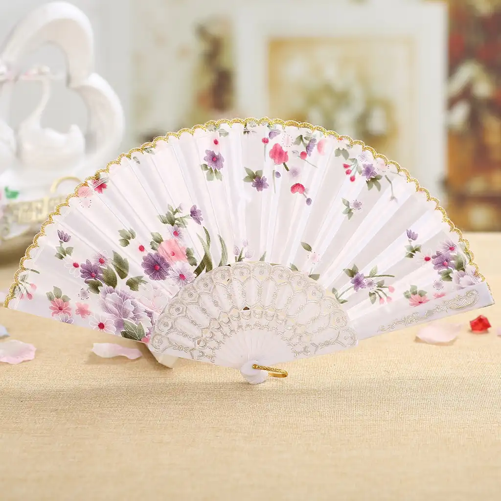 Close-up view of intricate silk fabric design showing detailed craftsmanship of Japanese folding fan.
