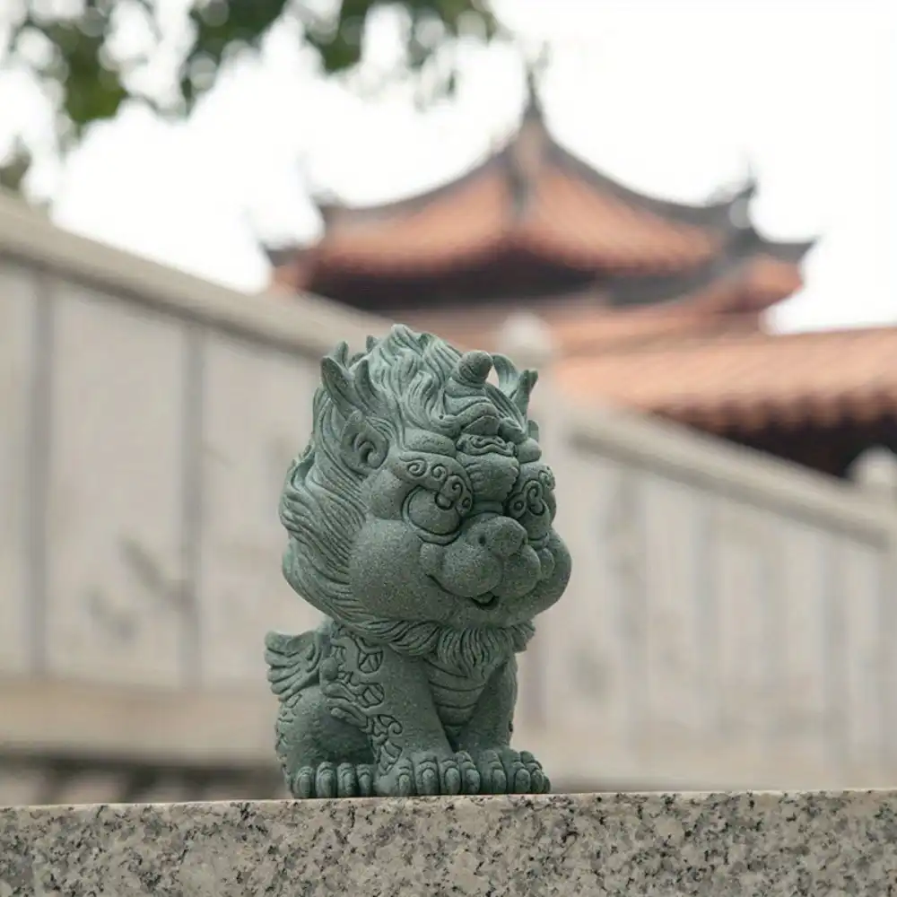 Green stone Qilin ornament positioned on office desk as tea pet and feng shui decoration.