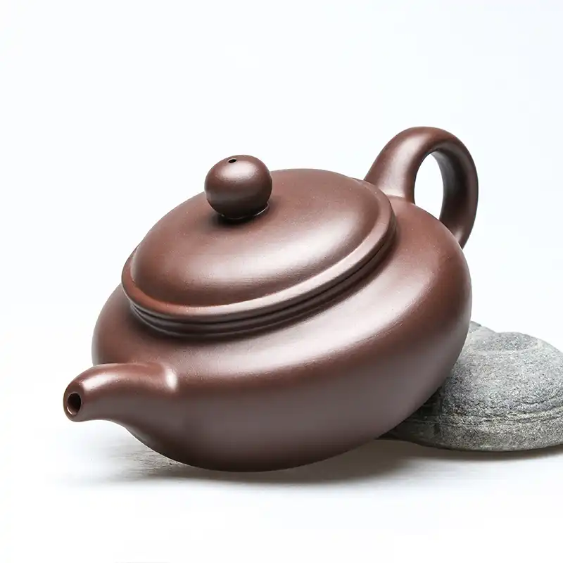 Traditional Xishi teapot lid detail showing perfect fit and authentic purple clay material quality.
