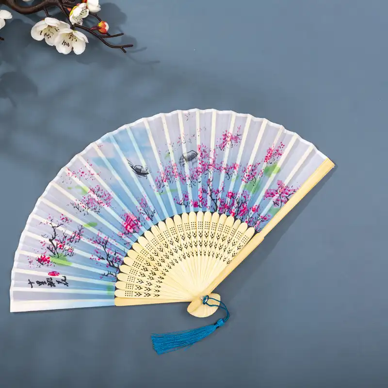 Dance performance with traditional Chinese fan as authentic cultural prop accessory.