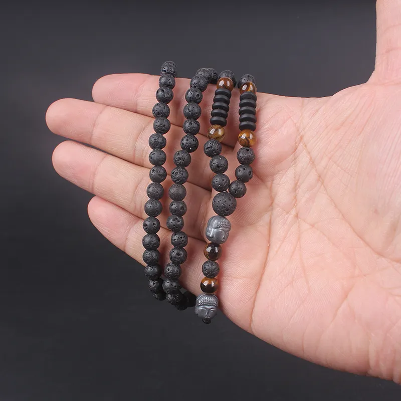 Man wearing Buddha tiger eye lava stone necklace lifestyle meditation spiritual healing jewelry.