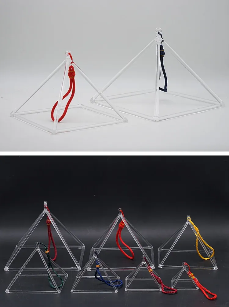 Crystal singing pyramid producing sound vibrations with rubber striking rod for healing meditation.