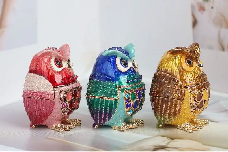 Side profile of cloisonne owl jewelry box highlighting detailed metalwork and craftsmanship.