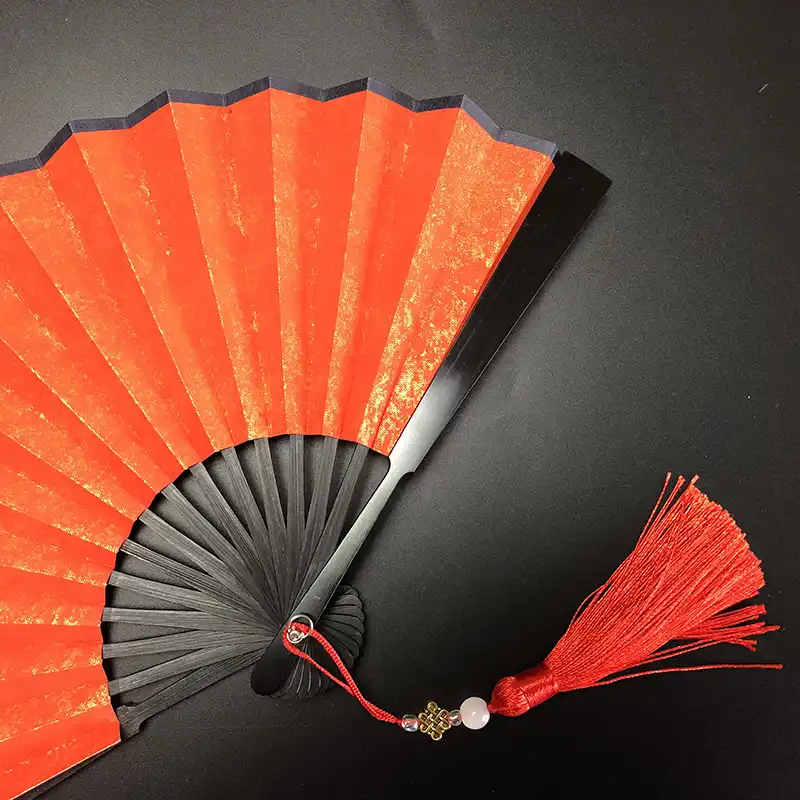 DIY craft session with paper fans showing painting and decorating activities for creative projects.