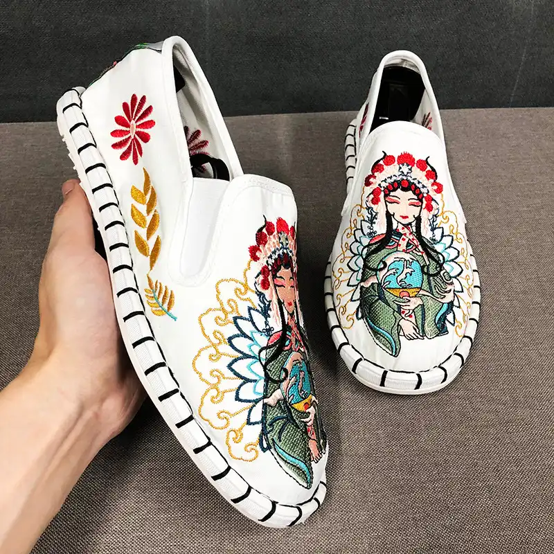 Close-up of animal print embroidered details on canvas upper showing traditional craftsmanship.