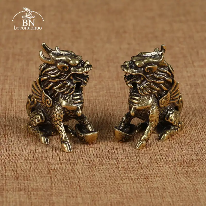 Antique bronze Qilin statue pair showing detailed copper craftsmanship and traditional Chinese design.