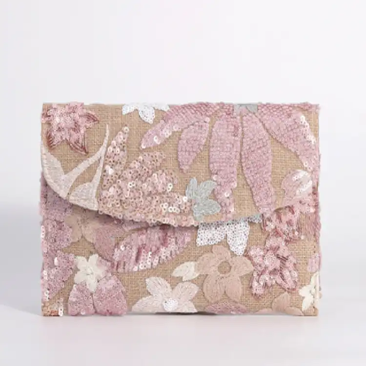 Close-up detail of intricate embroidery work and sparkling sequins on natural straw.