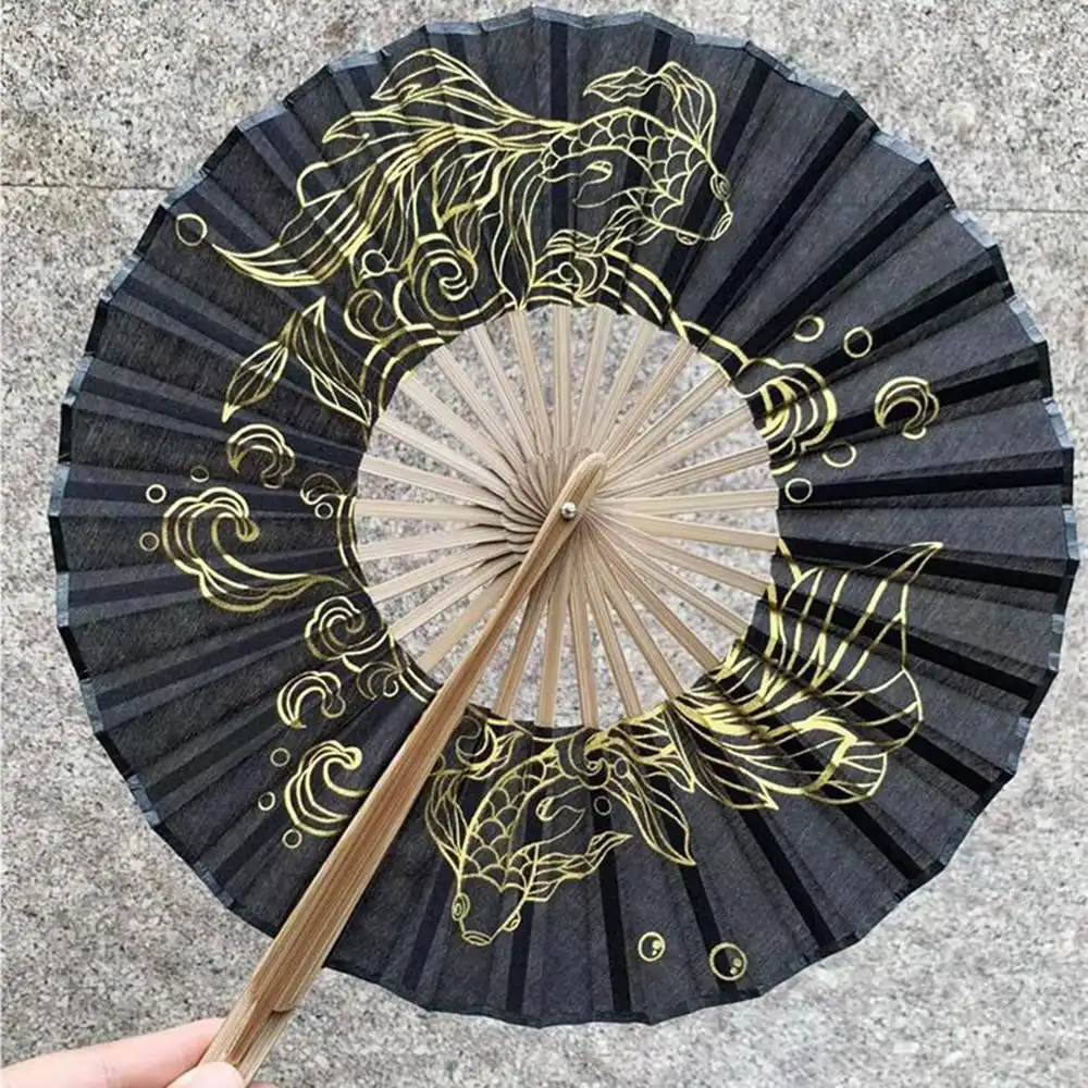 Japanese round bamboo hand fan with blue silk and decorative tassel displayed fully open.