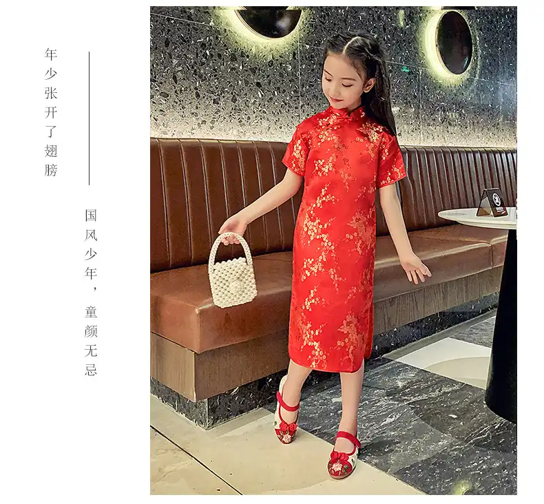 Young model wearing colorful children's cheongsam for party occasion photography.