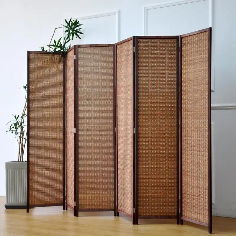 Large 67 inch high bamboo room divider creating separation between dining and living areas.