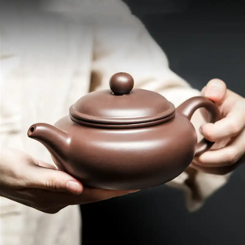 Yixing teapot bottom view displaying maker's mark and traditional handcrafted construction signature.