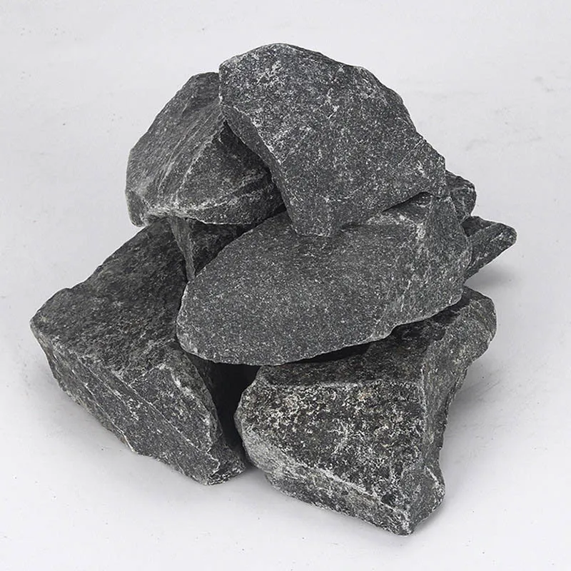 Close-up of porous volcanic sauna rocks demonstrating natural texture and steam absorption qualities.
