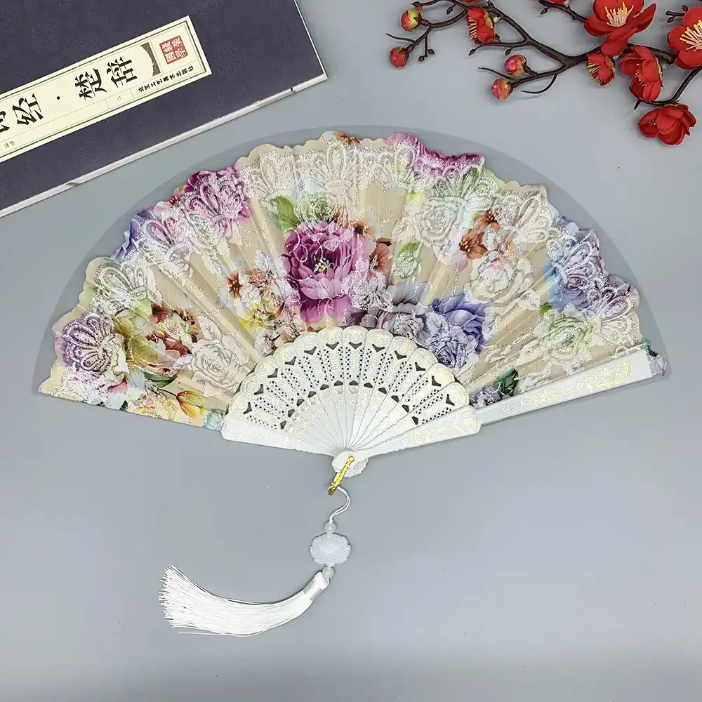 Multiple Japanese silk fans arranged showing color variations and gold foil designs.