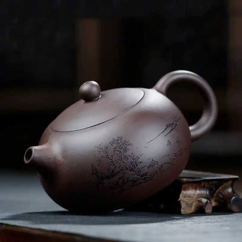 Side view of handmade zisha teapot displaying ergonomic handle and spout design for easy pouring.