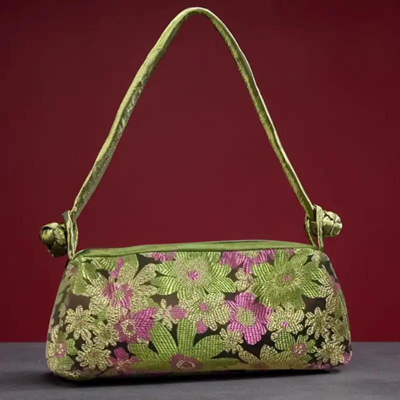 Close-up view of silk embroidery details highlighting intricate floral motifs and sparkle effect.