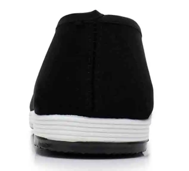 Pair of traditional Chinese martial arts shoes arranged on training mat showing authentic design.