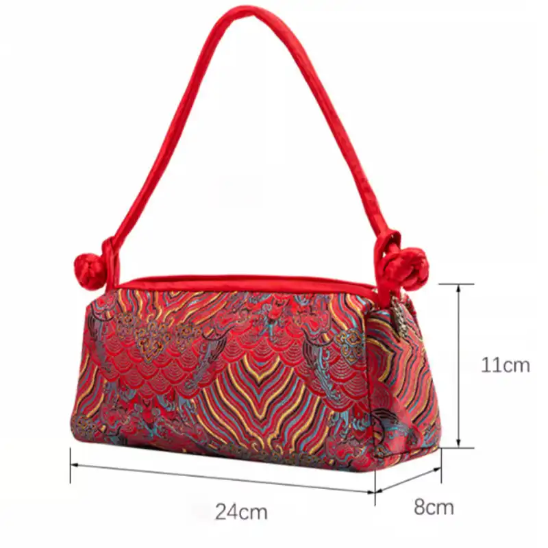 Interior compartment of silk embroidered bag showing polyester lining and spacious storage.