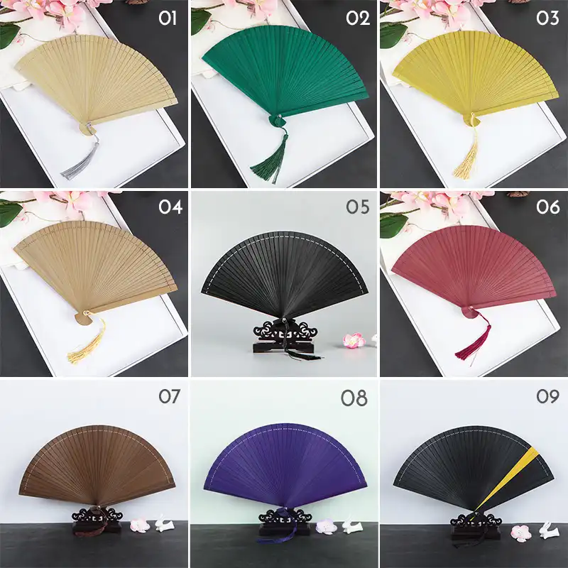 Closed folding bamboo fan showing compact portable size and traditional Chinese craftsmanship.