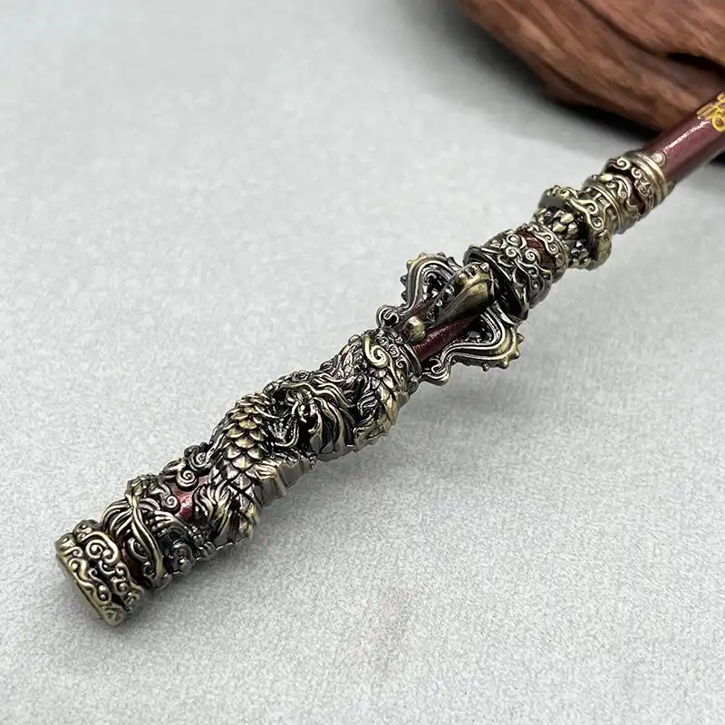 Close-up of Ruyi Jingu Bang metal staff electroplating finish and intricate engravings