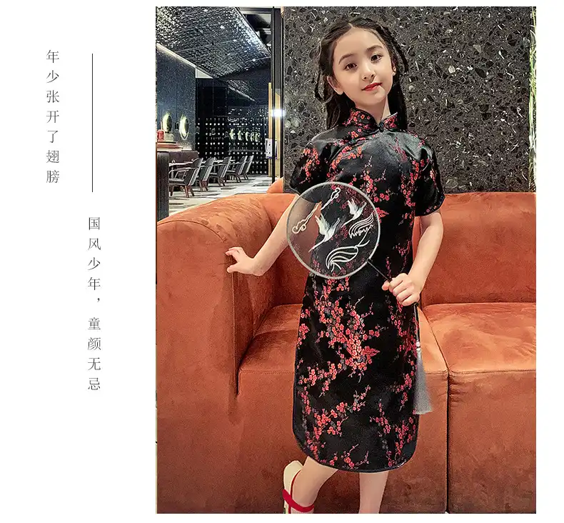 Child modeling summer cheongsam dress with princess style cut and floral patterns.