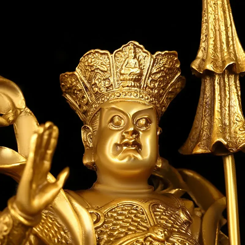 Four copper Buddha statues arranged in protective formation on modern living room shelf.