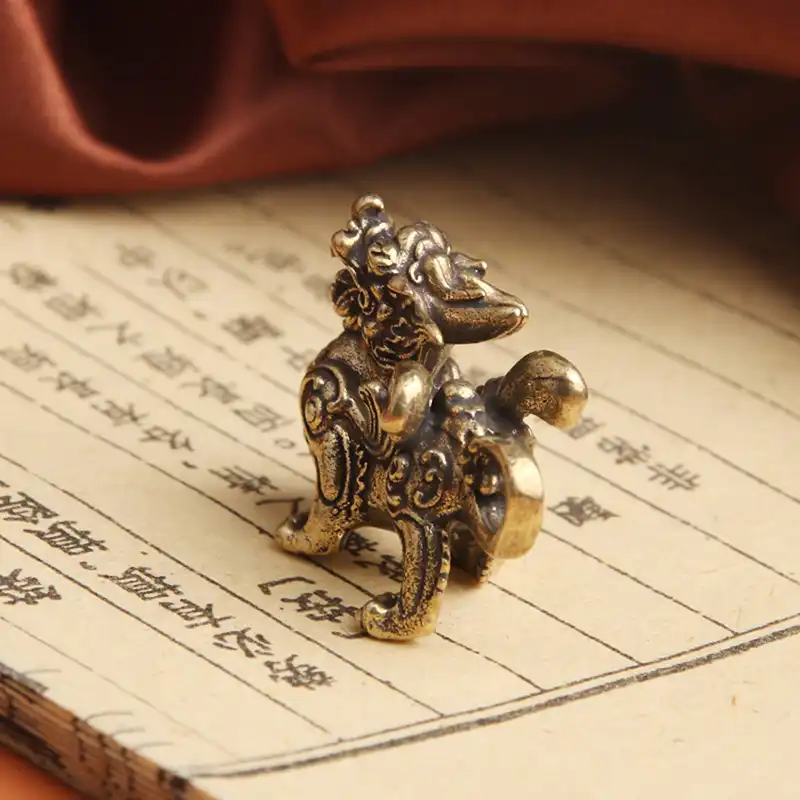 Brass Qilin ornament displayed on office desk as feng shui wealth attraction decoration.