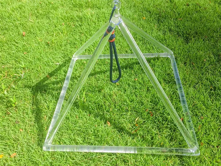 Multiple crystal pyramids arranged by size from 3 inches to 8 inches showing triangular tower design.