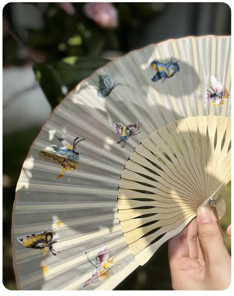 Japanese folding fan positioned as elegant home decoration accent in traditional setting.
