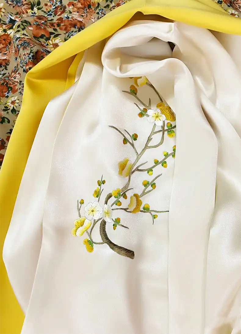Double layered silk scarf 155x35cm displaying elegant floral embroidery and smooth satin finish.