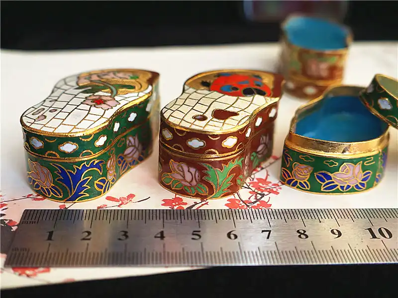 Side view of vintage cloisonne box displaying copper base construction and enamel coating quality.