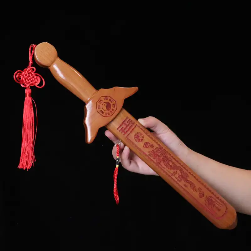 Close-up view of handcrafted peach wood sword showing smooth rounded edges and quality craftsmanship.