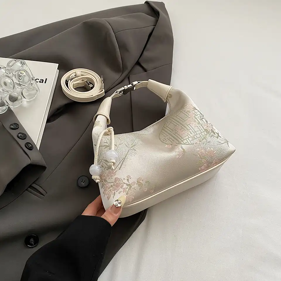 Designer silk crossbody bag showing elegant proportions and luxury construction.