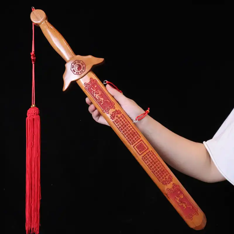 Child safely holding peach wood sword toy demonstrating proper grip and comfortable size.