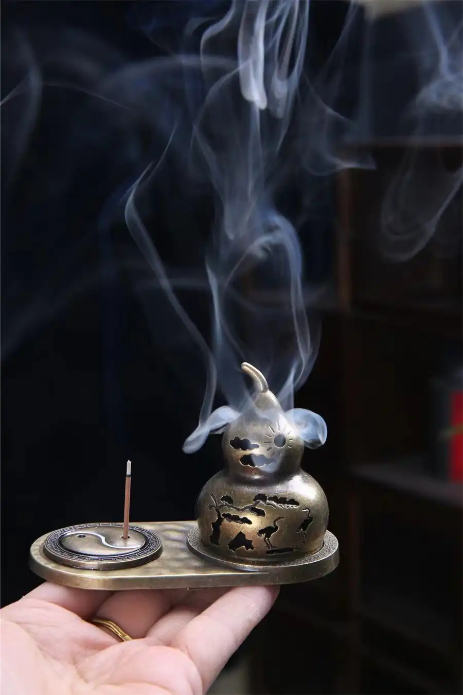 Close-up view of alloy incense holder showing intricate bagua patterns and bronze finish details.