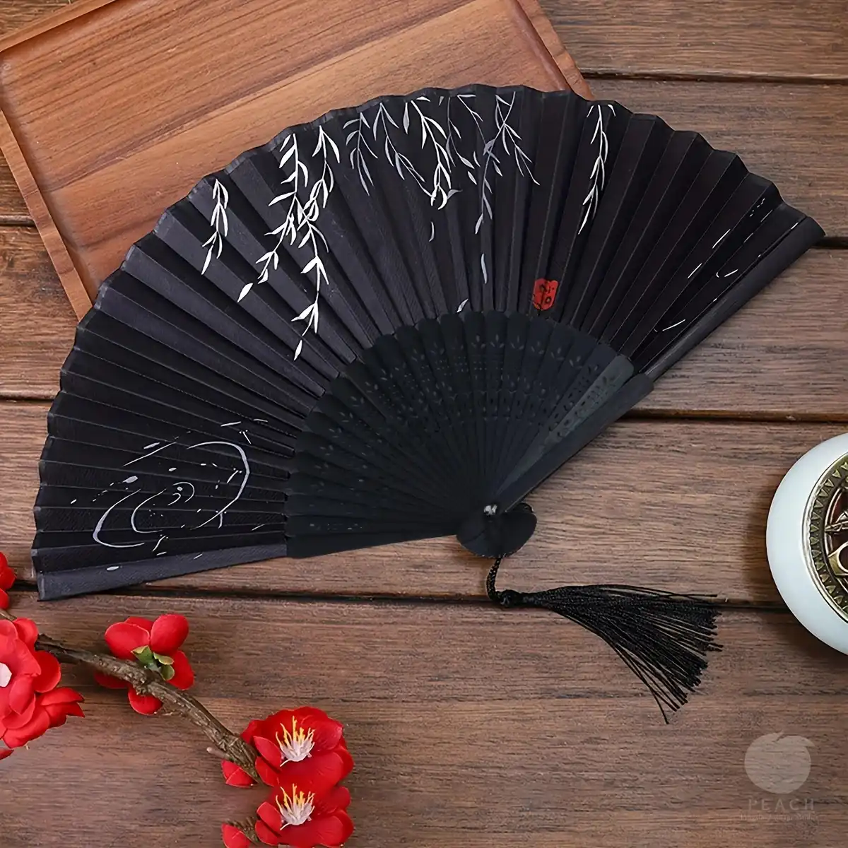 Chinese hand fan in wedding setting as elegant party favor accessory.
