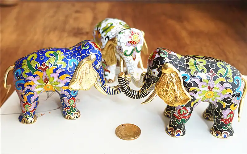 Full view of handcrafted cloisonne elephant showing intricate floral and geometric patterns.