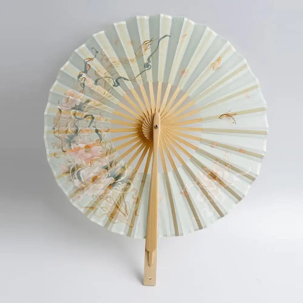 Green round bamboo fan highlighting vibrant color choice and traditional craftsmanship.