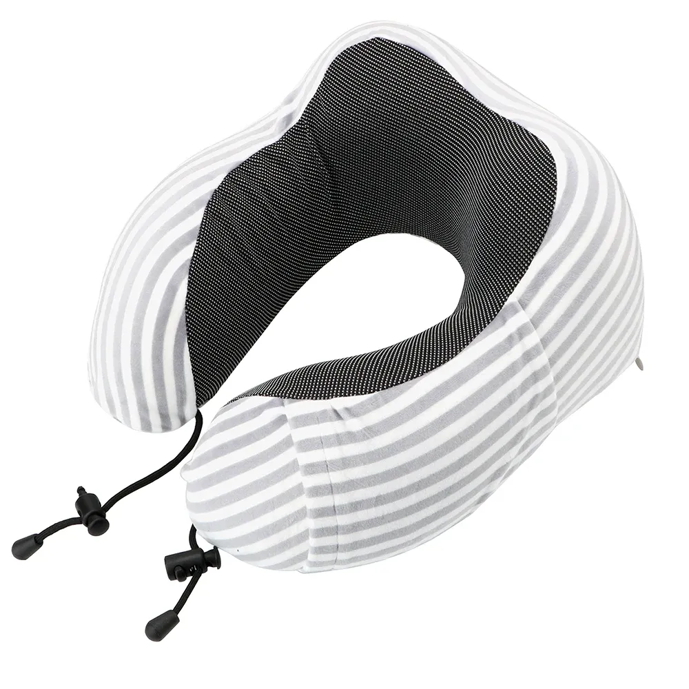 Person sleeping comfortably in car seat using U-shaped cervical support pillow during road trip.