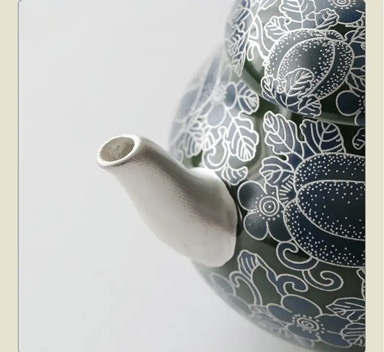 Elegant ceramic teapot featuring delicate butterfly and floral motifs in classical Chinese style.