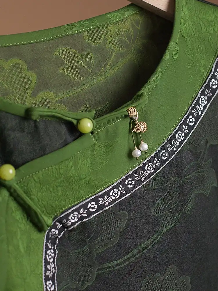 Close-up detail of luxurious Gambiered silk texture and quality craftsmanship on dress fabric.