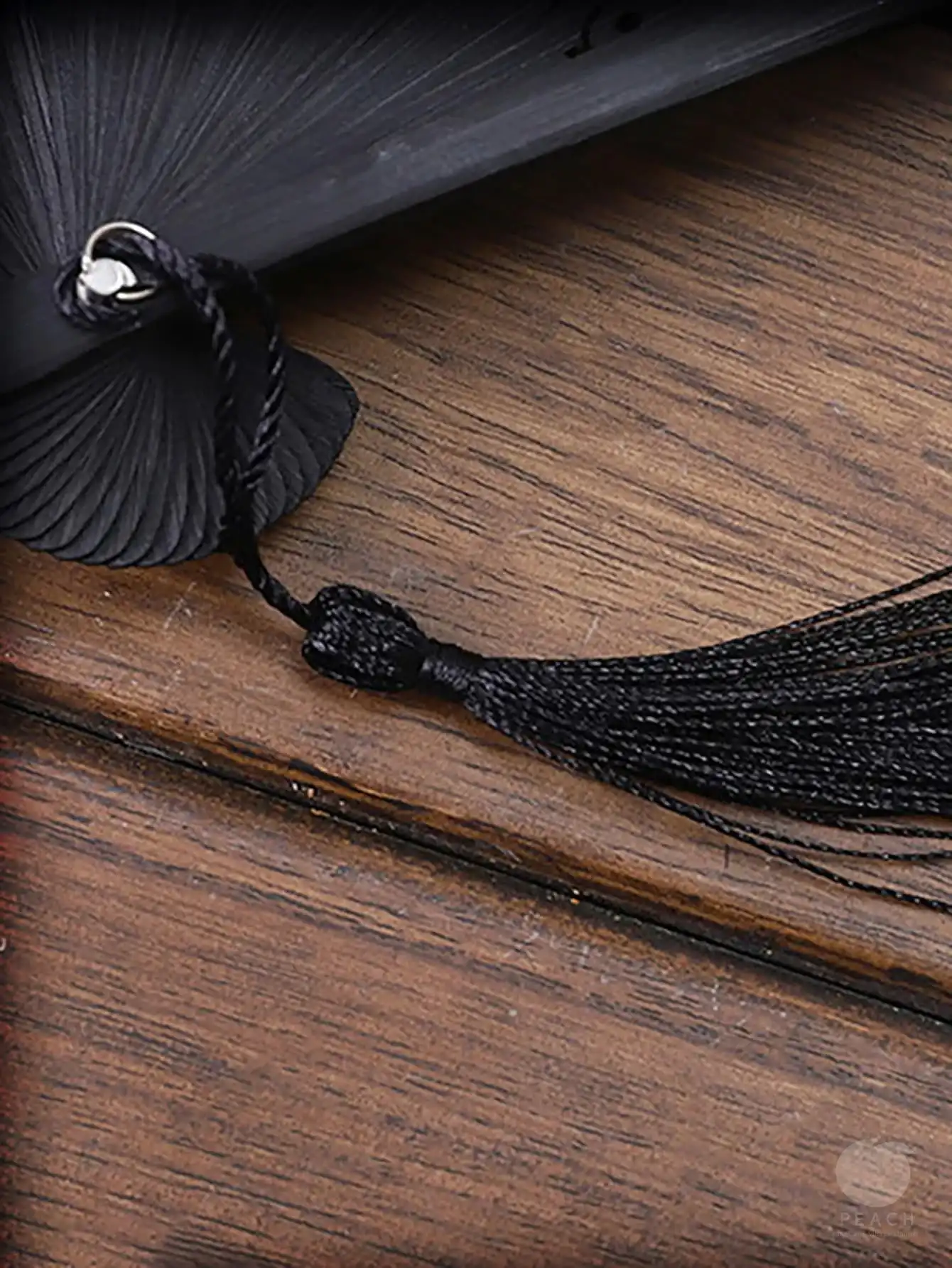 Close-up of fan pivot showing quality craftsmanship and smooth folding mechanism.
