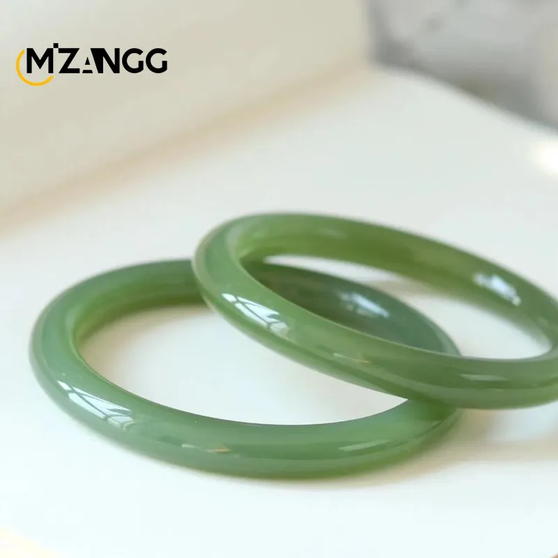Women wearing Hetian jade bracelet demonstrating size fit and elegant appearance on wrist for styling.