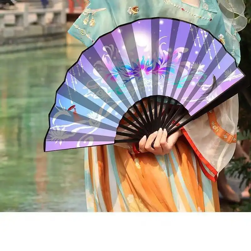 Outdoor use of bamboo folding fan during summer activities showing practical cooling function.