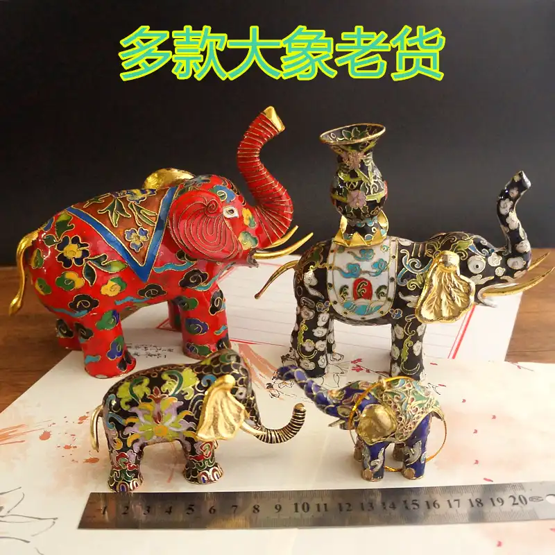 Close-up detail of copper wire cloisons filled with colorful enamel on elephant surface.