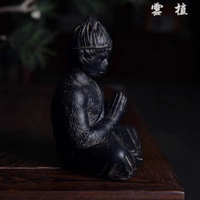 Garden placement of stone Sun Wukong statue surrounded by plants demonstrating outdoor decorative versatility.
