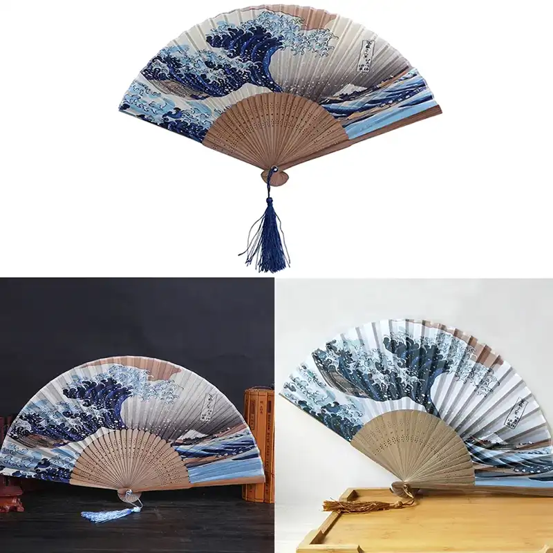 Japanese woman holding opened Kanagawa wave folding fan demonstrating elegant use and perfect sizing.