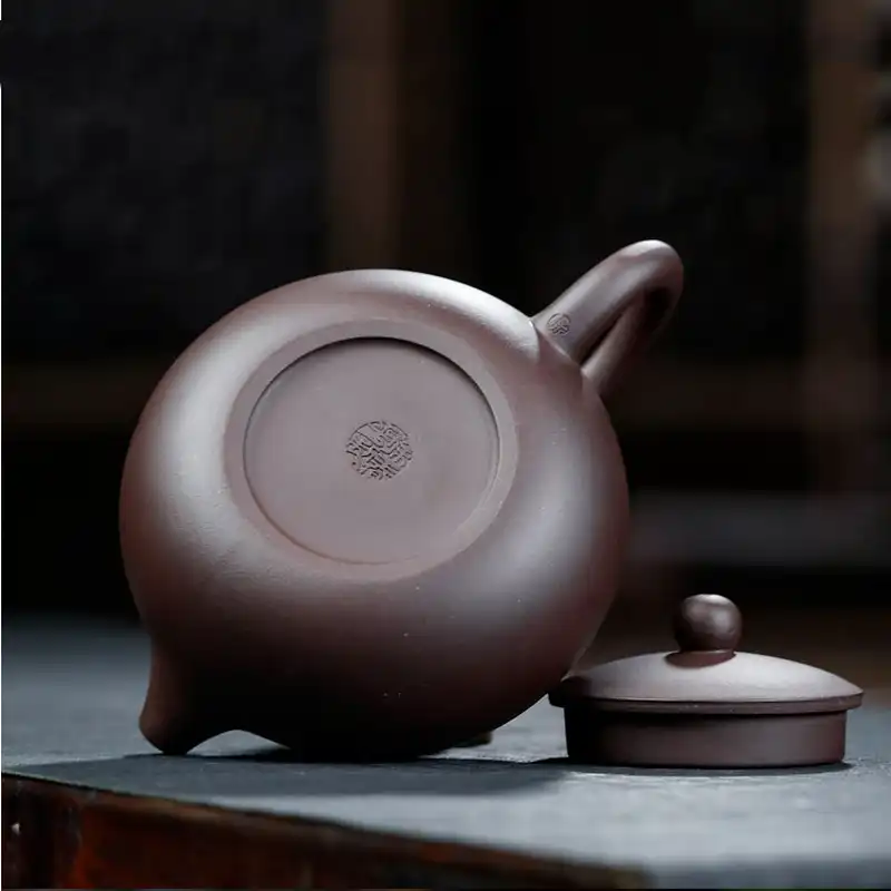 Traditional Chinese teapot in use demonstrating proper gongfu tea brewing technique and setup.